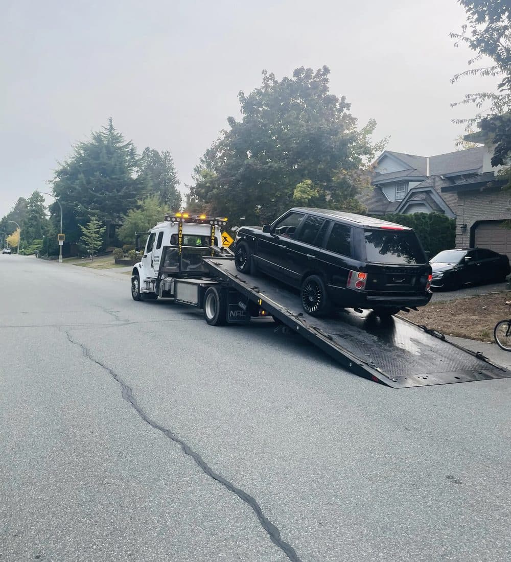 Tow truck driver securing a vehicle for removal